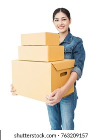 Portrait of happy delivery asian woman wearing jeans her hands holding cardboard box isolated on white background, young asian woman carry brown box moving house delivery service concept