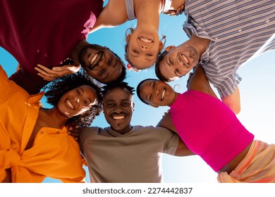 Portrait of happy diverse friends embracing and smiling at beach, with copy space. Spending quality time, lifestyle, friendship, summertime and holiday concept. - Powered by Shutterstock