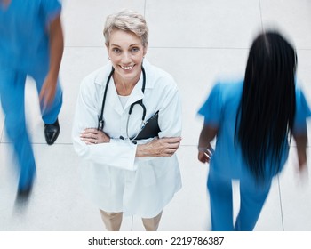 Portrait, Happy And Doctor In Busy Hospital Standing With Crossed Arms After Consultation. Happiness, Medicine And Senior Healthcare Professional With Stethoscope Working In Medical Clinic In Canada.