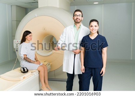 Portrait of a happy doctor and radiologist smiling while waiting with a patient after doing a magnetic resonance medical exam
