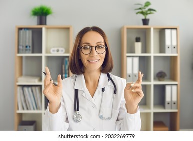 Portrait Of Happy Doctor Talking And Gesturing During Online Consultation Via Video Call. Webcam Headshot Of Professional Physician In White Lab Coat Counseling Patient During Remote Visit To Clinic