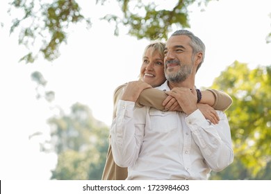 Portrait Of Happy Elderly Couple Hug Together, Take Care And Love With Good Relationship, Good Health And Romantic In The Park, Retirement Insurance And Lovely Couple Concept