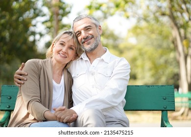 Portrait of happy elderly couple hug together, take care and love with good relationship, good health and romantic in the park, retirement insurance and lovely couple concept - Shutterstock ID 2135475215