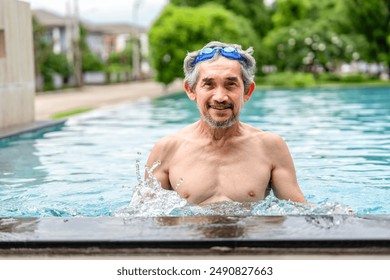 portrait happy elderly man with goggles in swimming pool,healthy asian senior male enjoying his summer vacation at resort,senior pensioner people travel and relaxing - Powered by Shutterstock