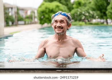 portrait happy elderly man with goggles in swimming pool,healthy asian senior male enjoying his summer vacation at resort,senior pensioner people travel and relaxing - Powered by Shutterstock