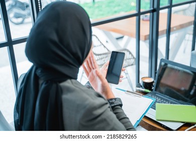 Portrait Of Happy Excited Muslim Woman Suprised While Looking At Her Phone