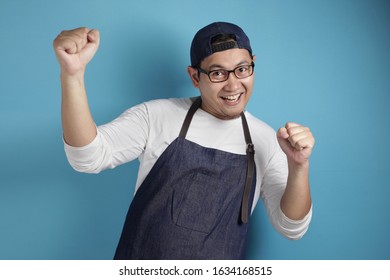 Portrait Of Happy Excited Proud Asian Chef Or Waiter Dancing Happily Espressing Victory, Against Blue Background