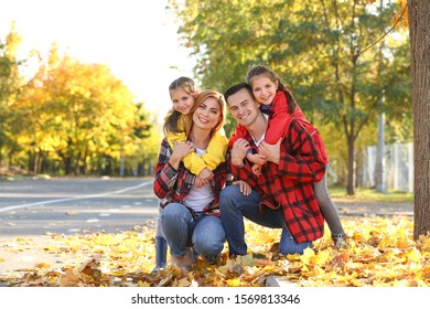 Portrait Of Happy Family In Autumn Park