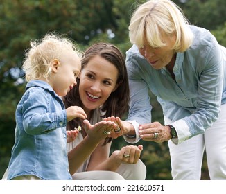 Portrait Of A Happy Family With Baby Mother And Grandmother Outdoors