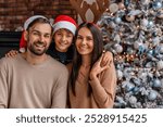 Portrait of happy family celebrating Christmas together at home. Parents and son kid child hugging embracing looking at the camera. Happy New Year Eve!