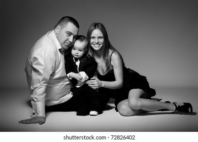 Portrait Of Happy Family With Child. Studio Shot.