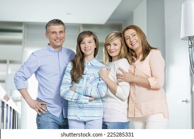 Portrait Of Happy Family With Children Standing Together At Home