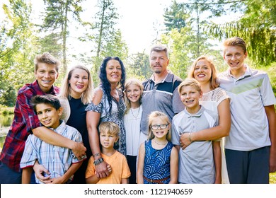 Portrait of happy family of eleven posing in park