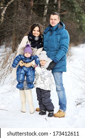 Portrait Of Happy Family Enjoying Beautiful Winter Day Outdoors