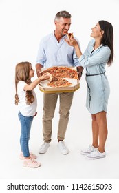 Portrait Of A Happy Family Father, Mother, Little Daughter Holding Big Pizza In Box Isolated Over Gray Background