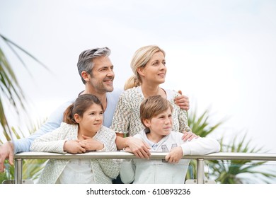 Portrait of happy family of four standing outside - Shutterstock ID 610893236