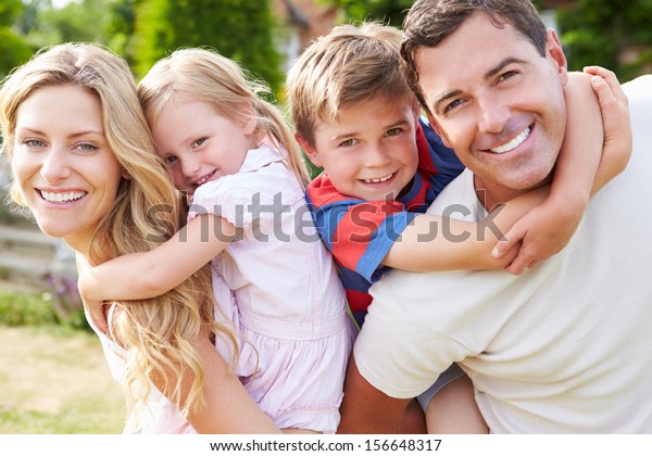 Portrait Of Happy Family In\
Garden