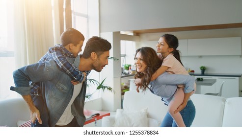 Portrait Of Happy Family Having Fun  In Slow Motion On Kitchen . Concept Of Happy Family, Childhood, Parenthood