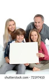 Portrait Of Happy Family Holding White Message Board