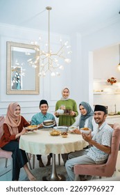 portrait of happy family look at camera together in the dining room when breaking fast - Shutterstock ID 2269796927
