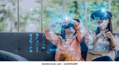 Portrait of happy family mother and asian girl use glasses of technology virtual reality headset for fashion online shopping time summer sale and buy something purchases.online VR metaverse technology - Powered by Shutterstock