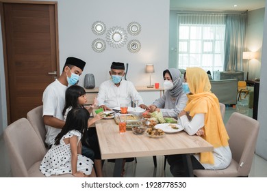 Portrait Of Happy Family Muslim Wear Mask During Eid Mubarak Celebration At Home