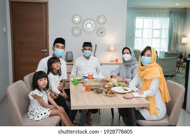 Portrait Of Happy Family Muslim Wear Mask During Eid Mubarak Celebration At Home