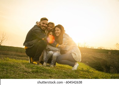 Portrait Of Happy Family In The Par. Looking At Camera. Space For Copy.