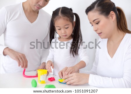 Portrait of Happy family play clay together  at home. People lifestyle concept.