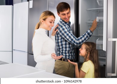 
Portrait Of Happy Family Selecting New Refrigerator In Appliance Store    
