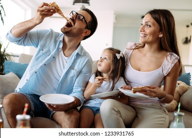 Portrait Of Happy Family Sharing Pizza At Home