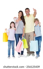 Portrait Of Happy Family With Shopping Bags Gesturing Thumbs Up Over White Background