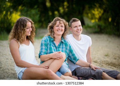 Portrait of a happy family sitting together, closely bonded.