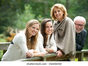 Portrait Of A Happy Family Smiling Together Outdoors