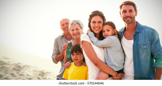 Portrait of happy family standing at beach - Powered by Shutterstock