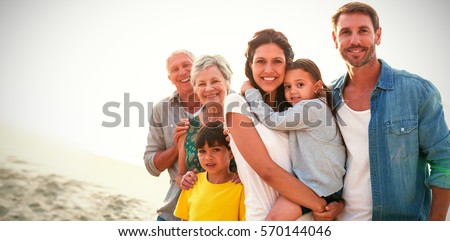 Portrait of happy family standing at beach