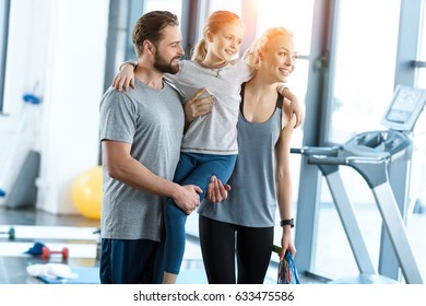 Portrait Of Happy Family Standing Together At Fitness Center