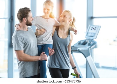 Portrait Of Happy Family Standing Together At Fitness Center