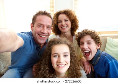 Portrait Of A Happy Family Taking A Selfie At Home