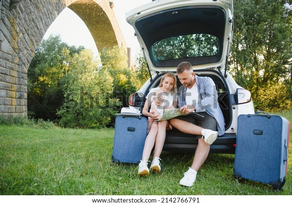 Portrait of\
happy family. Vacation, Travel - family ready for the travel for\
summer vacation. suitcases and car\
route.