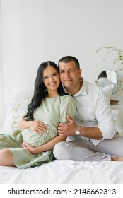 Portrait Of A Happy Family Waiting For A New Family Member - A Child