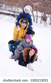 Portrait of happy family in the winter. Smiling parents with their children. Handsome father and beautiful mother with little cute daughters having fun in the show park. Pretty kids, nice woman - Shutterstock ID 1305213031