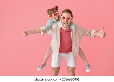 Portrait Of Happy Father And Daughter Showing Thumb-up On Color Background