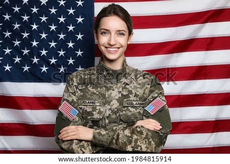 Portrait of happy female cadet against American flag