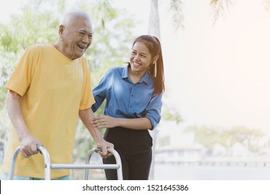 Portrait of happy female caregiver and senior man while using walker or Zimmer frame walking or exercise together at outdoor. Assisting the elderly or disabled Physiotherapy and Rehabilitation concept - Powered by Shutterstock