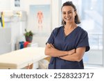 Portrait of happy female caucasian physiotherapist wearing scrubs at hospital. Hospital, physiotherapy, work, medicine and healthcare, unaltered.