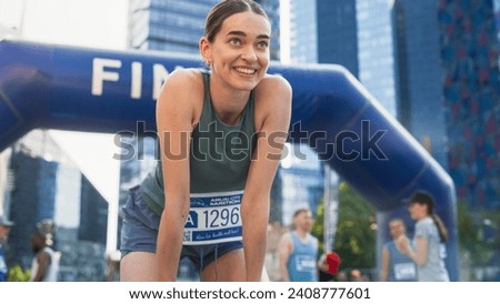 Portrait of a Happy Female City Marathon Runner Crossing the Finish Line and Celebrating her Victory. Female Race Winner Achieving her Goal and Enjoys her Accomplishement