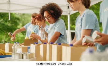 Portrait of a Happy Female Volunteer Preparing Free Food Delivery for Low Income People. Charity Workers and Members of the Community Work Together in Local Humanitarian Aid Donation Center. - Powered by Shutterstock