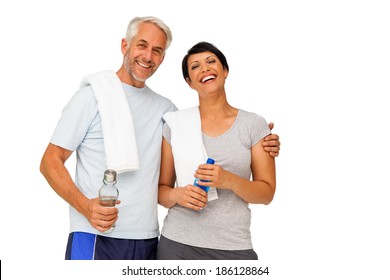 Portrait of a happy fit couple standing over white background