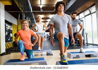 Portrait of happy fit people, friends exercising in gym together. Sport people workout concept - Powered by Shutterstock